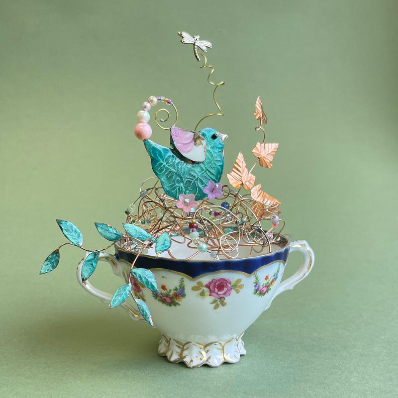 Bird on a tea cup nest