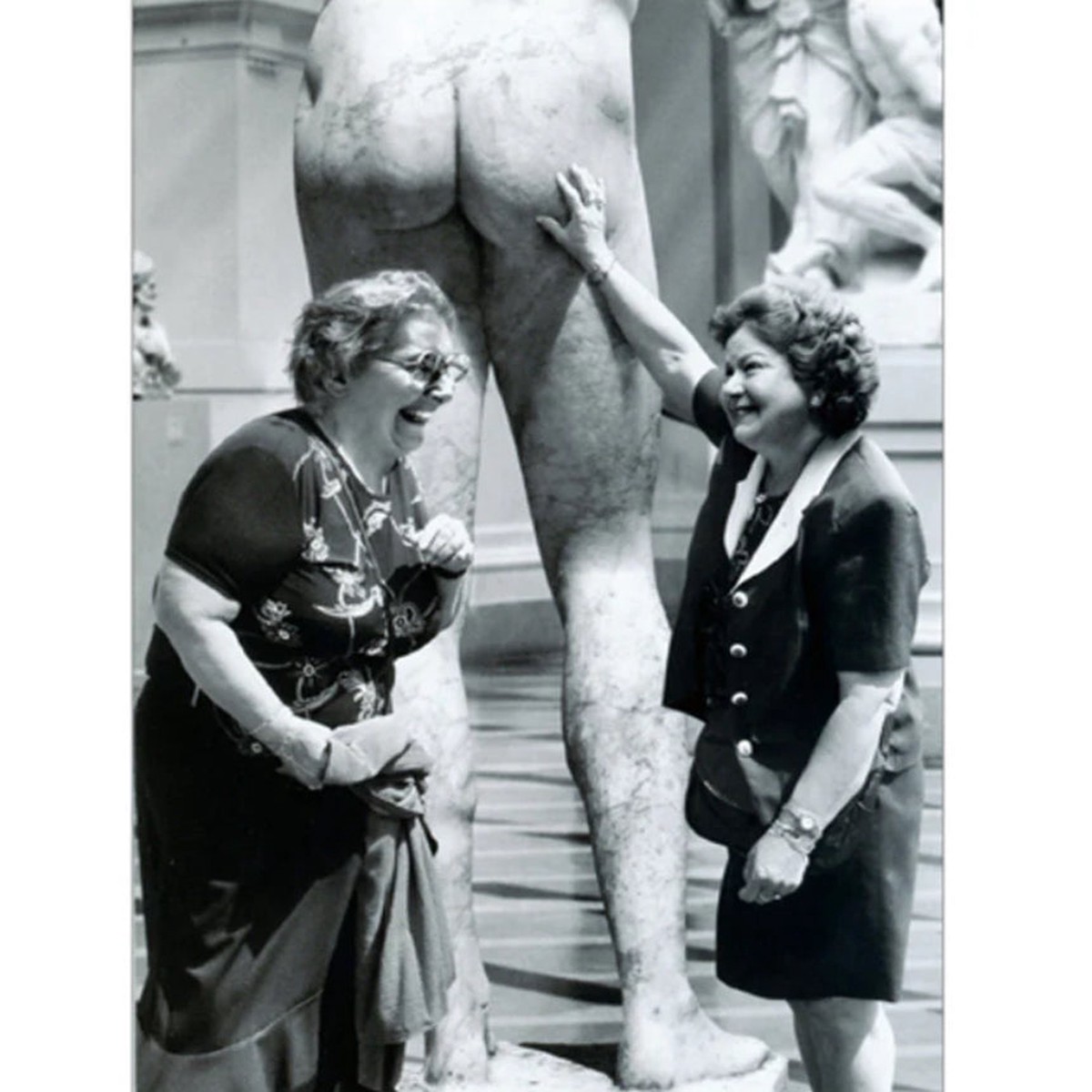 WOMEN TOUCHING STATUE
